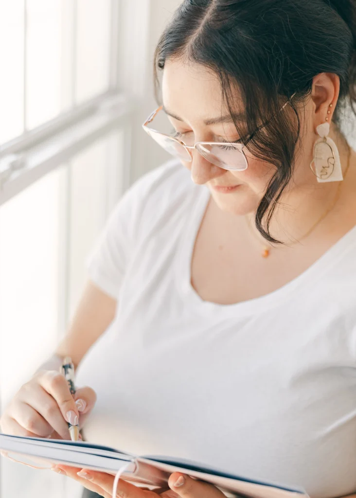 a closeup of Kimberly looking down and sketching in her sketch book